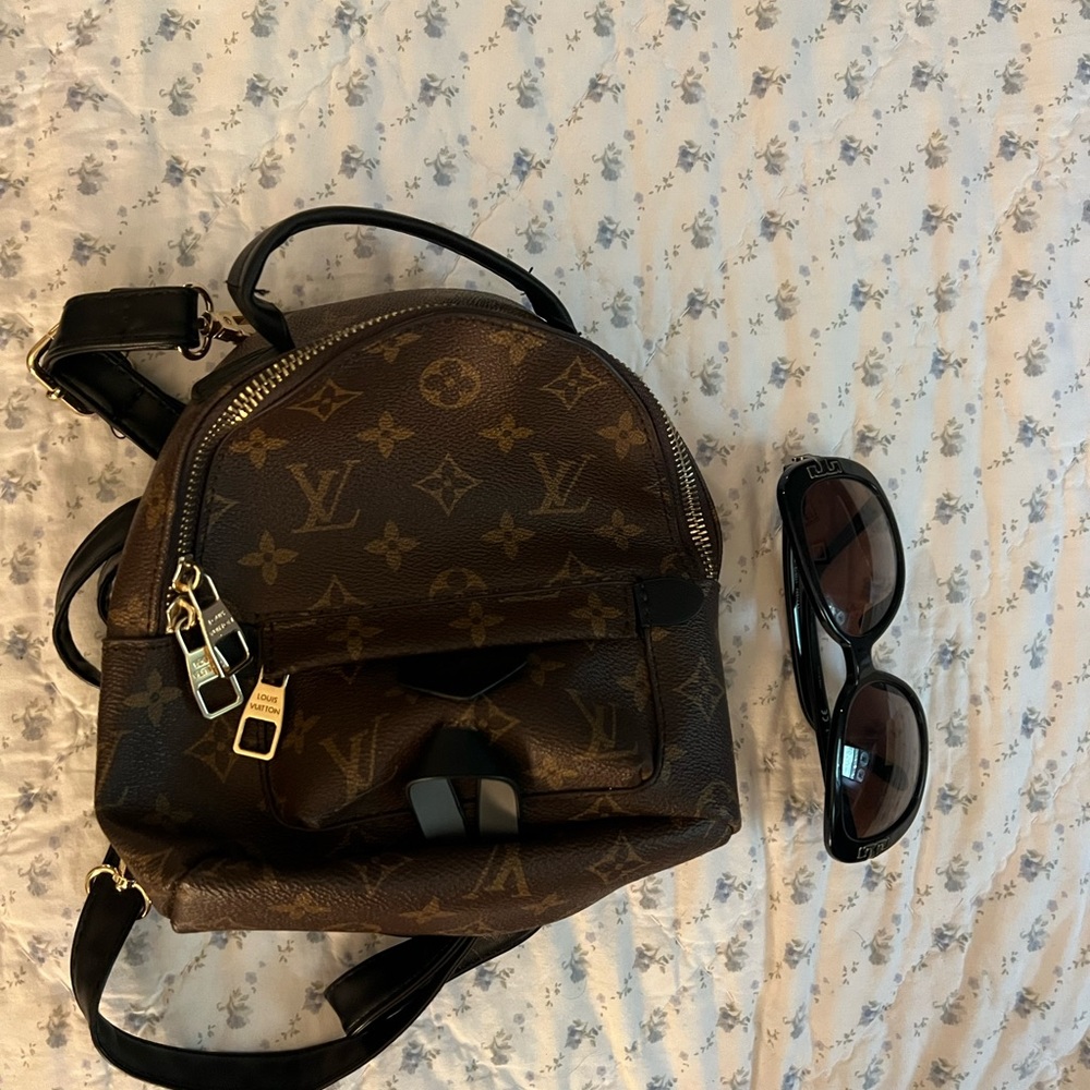A small size Faux Leather backpack / sunglasses for size. Brand new no tags.